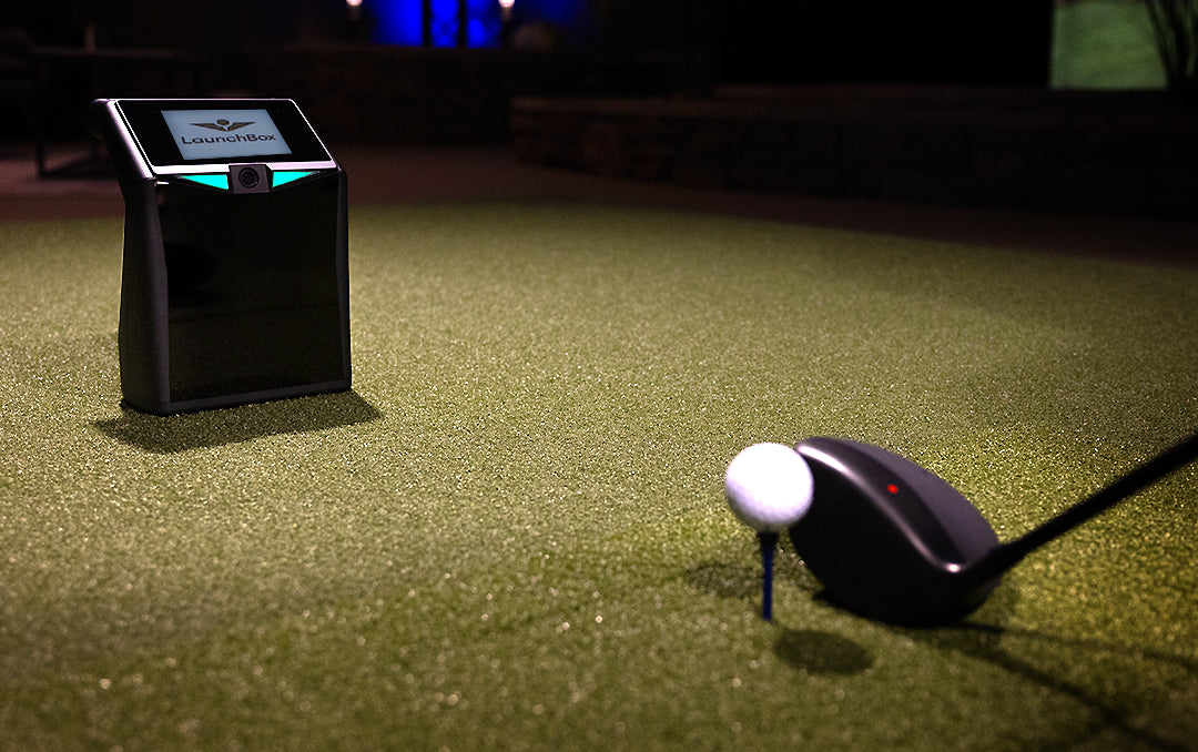 TruGolf LaunchBox simulator installed in a home with enclosure, projector, and virtual course displayed
